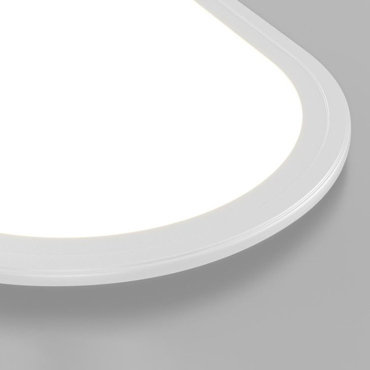 Close view of the rounded end of a lit white Edge light, showing its filled bright face and thin stepped rim.