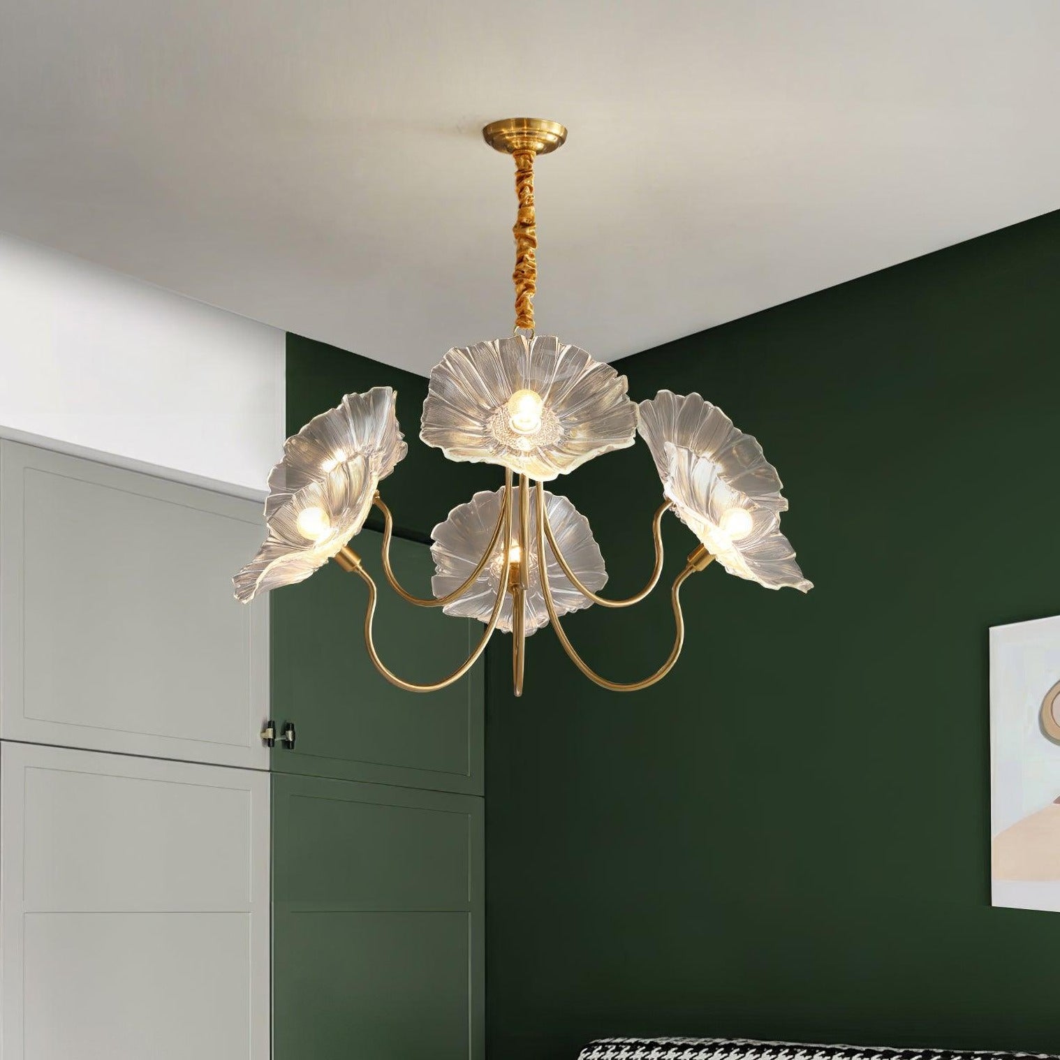 Clear flower chandelier near a green bedroom wall