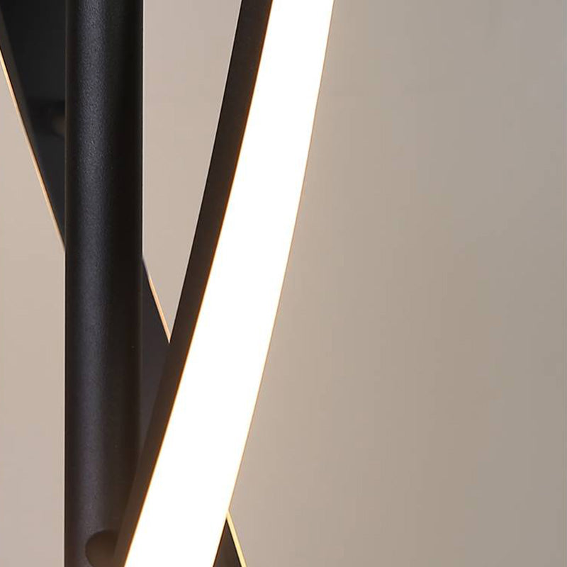 Close-up of a bright acrylic diffuser face along a curved black light strip beside the central stem