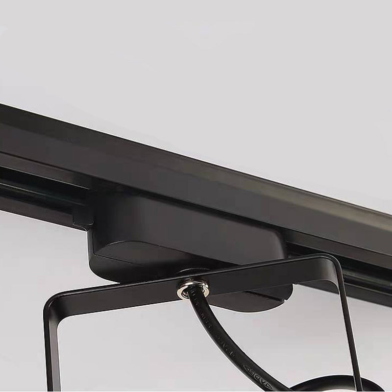 Close black track-style adapter and rail above an Alessio bracket, cable and fixing bolt.