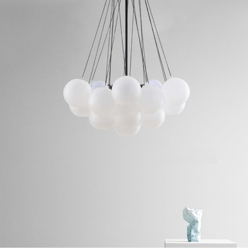 Unlit white-looking globes beneath black suspension lines
