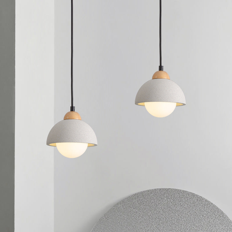 Two dome-shaped Ozawa Style A pendants at staggered heights near a curved wall feature.