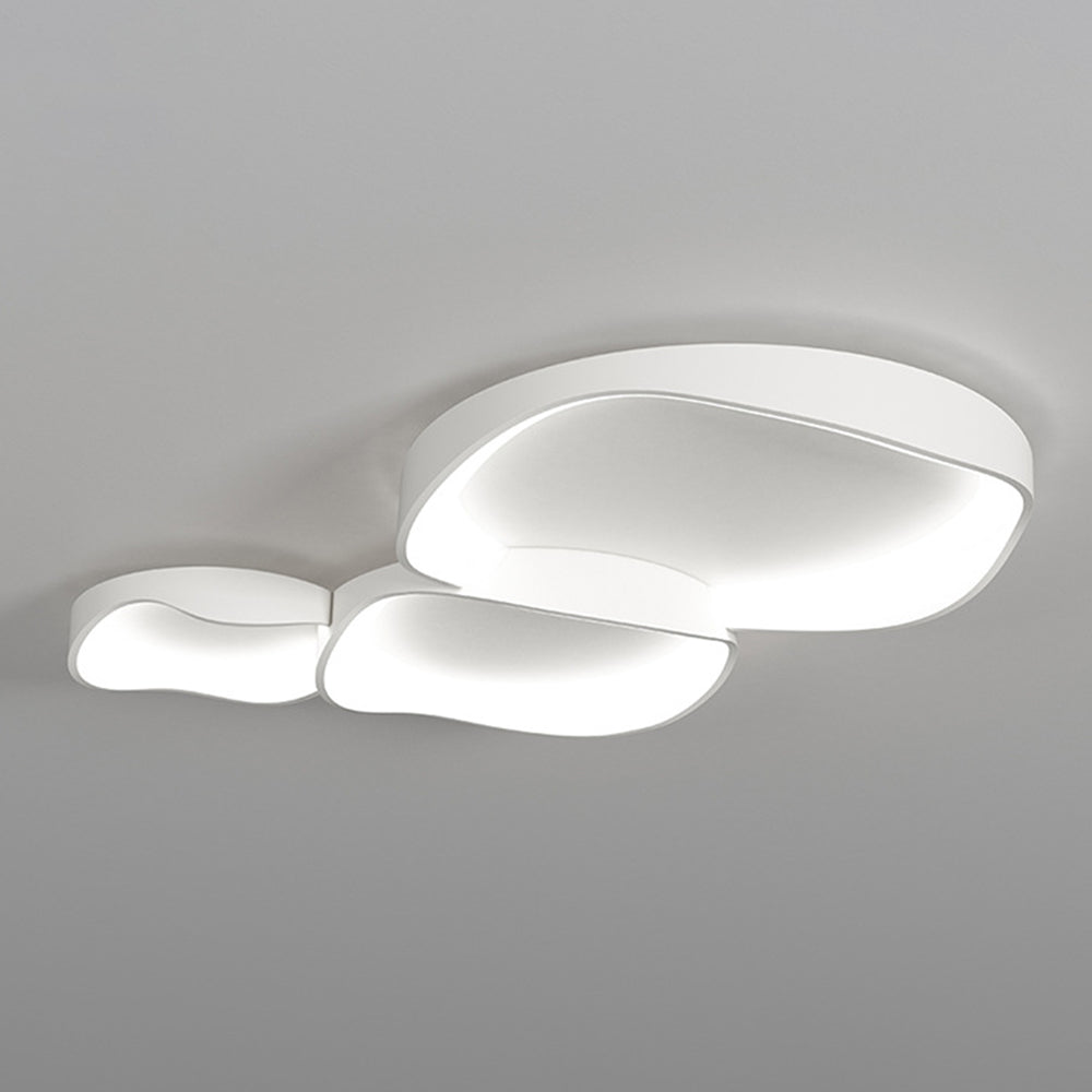 Installed three-bowl Arisha light with white wave edges and cool-looking pale illumination against a plain ceiling.