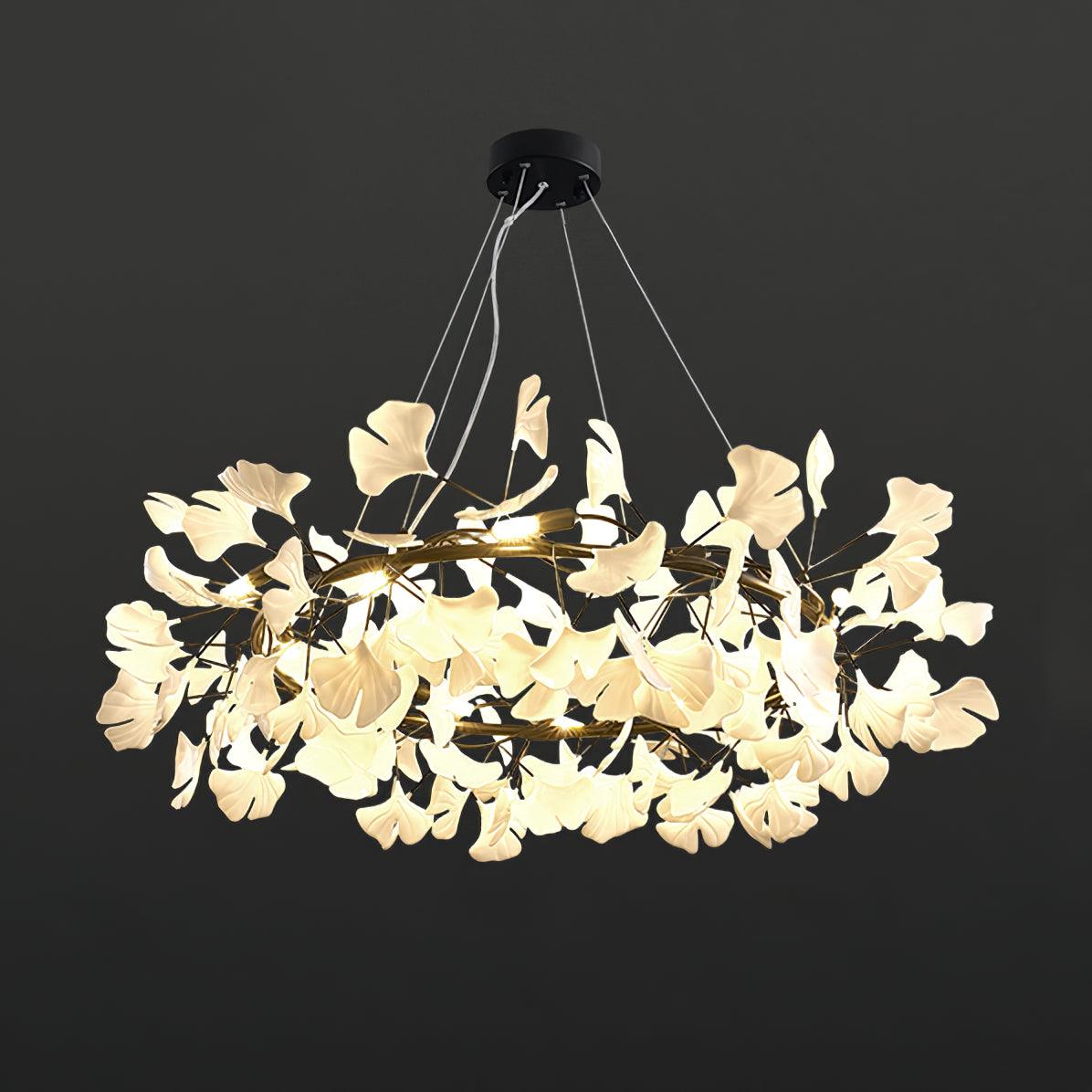 Black-frame chandelier with illuminated pale ceramic leaves