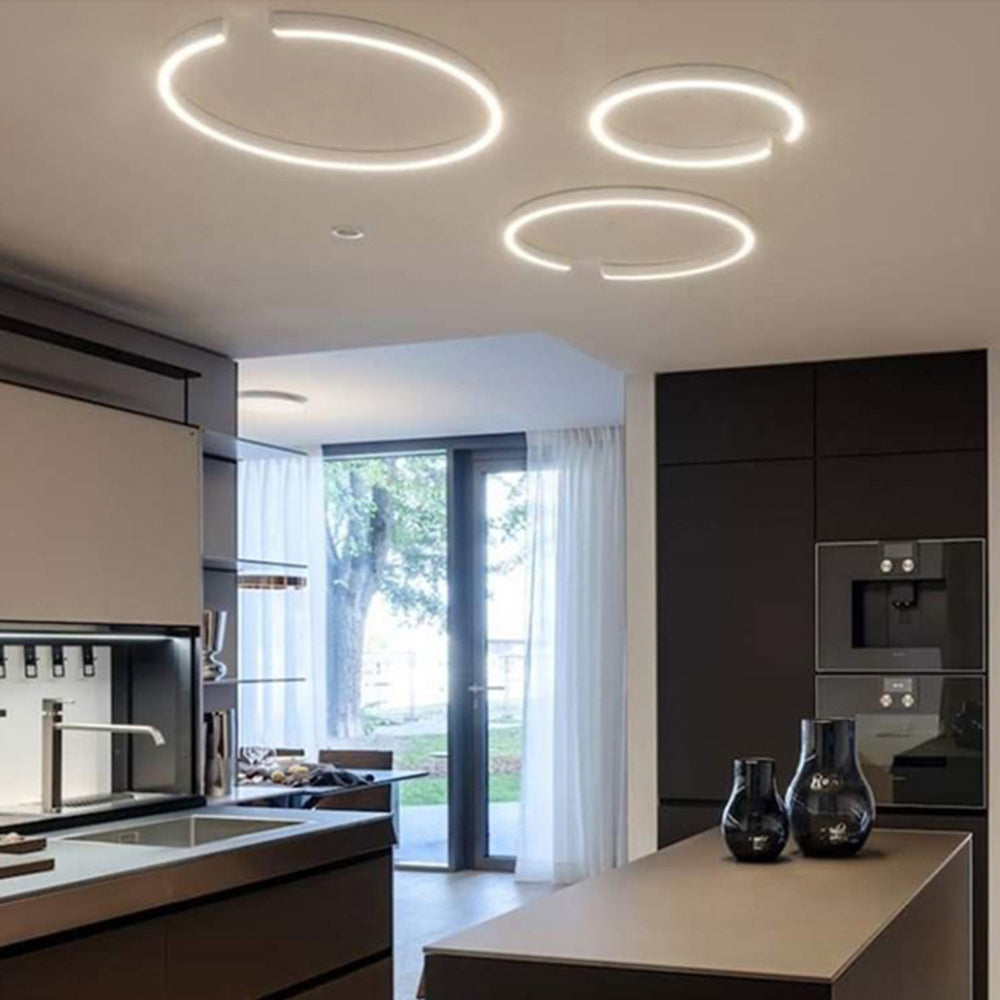Three illuminated Edge ceiling rings above a kitchen