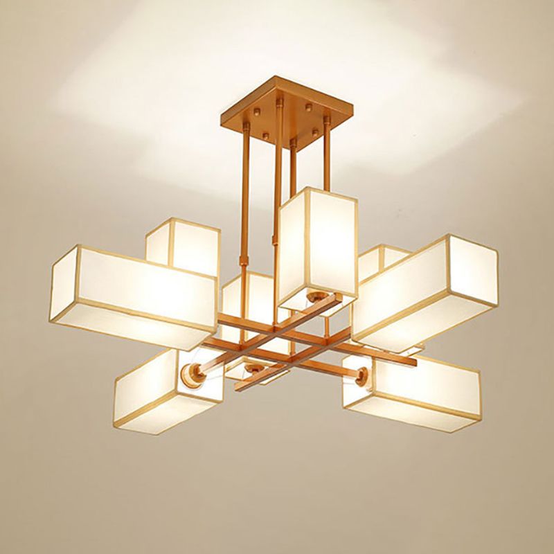 Gold 8-Light chandelier with crossed arms and fabric boxes