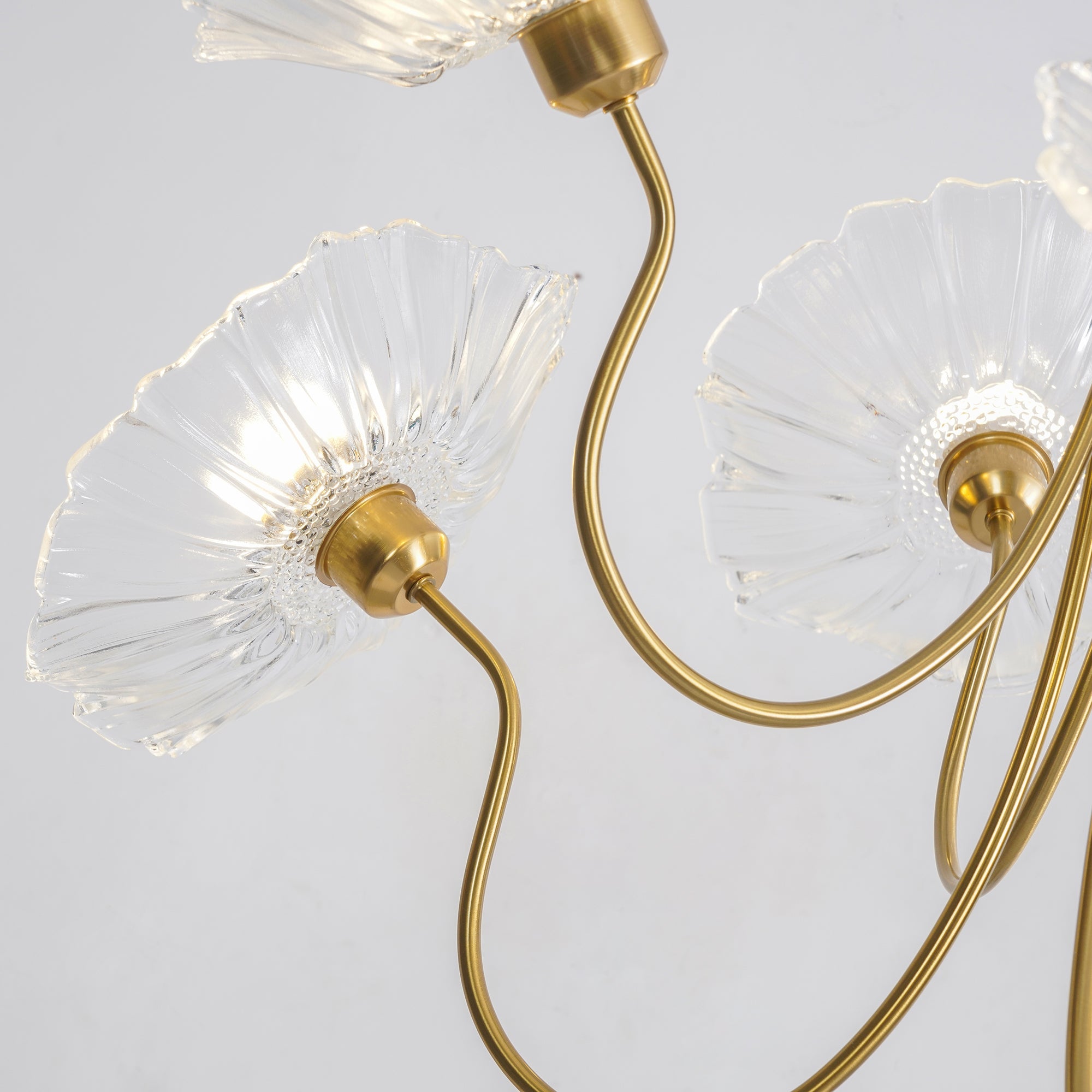 Curved metal arms and rear of clear glass flowers