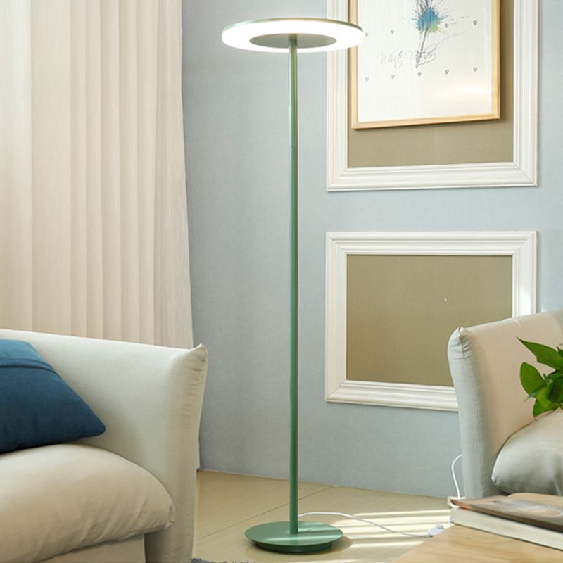 Morandi green disc floor lamp beside a sofa