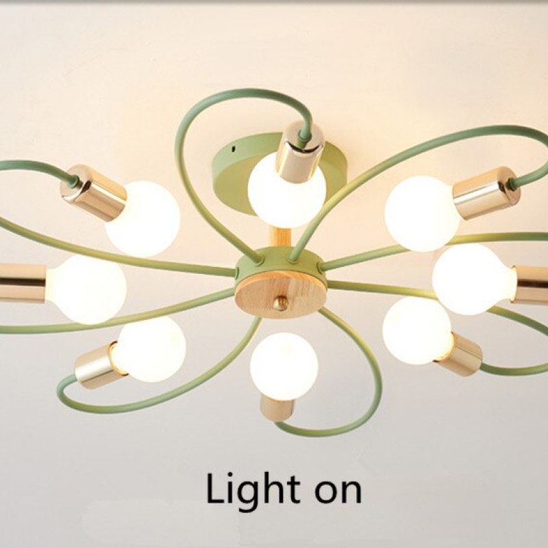 Green eight-head ceiling light switched on, showing glowing round bulbs and a wood-grain central disc