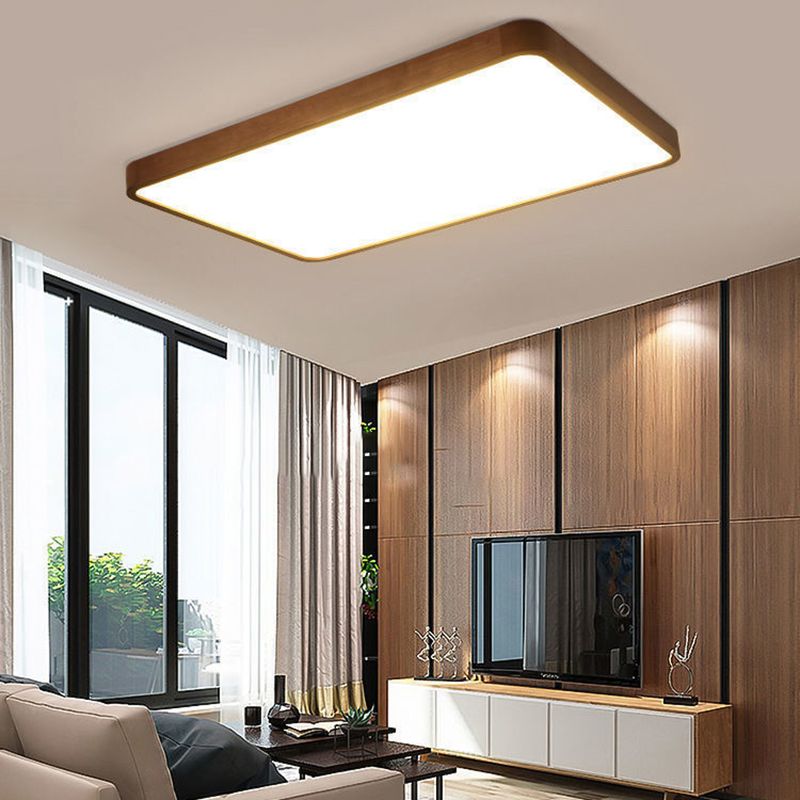 Rectangular Ozawa light above a sofa near a wood-panelled TV wall, dark-framed window and curtains.