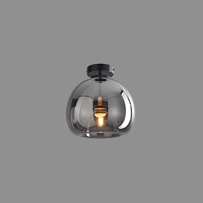 Black Sanna short-stem ceiling light isolated on grey background with round canopy, smoky-looking dome glass and bulb.