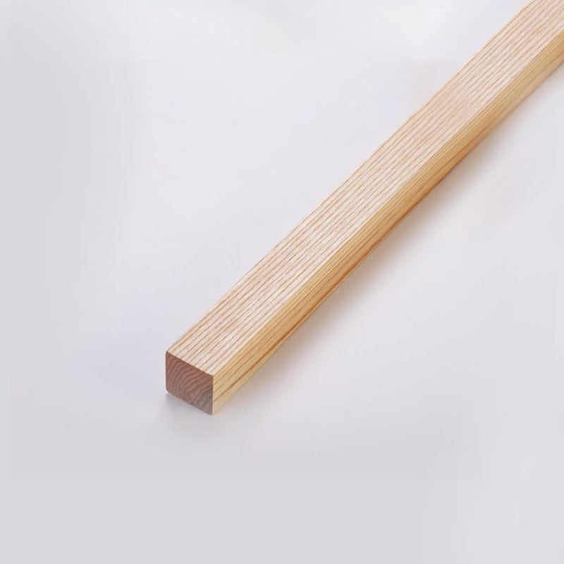 Close-up of the light woodgrain bar and rectangular end face on a pale background