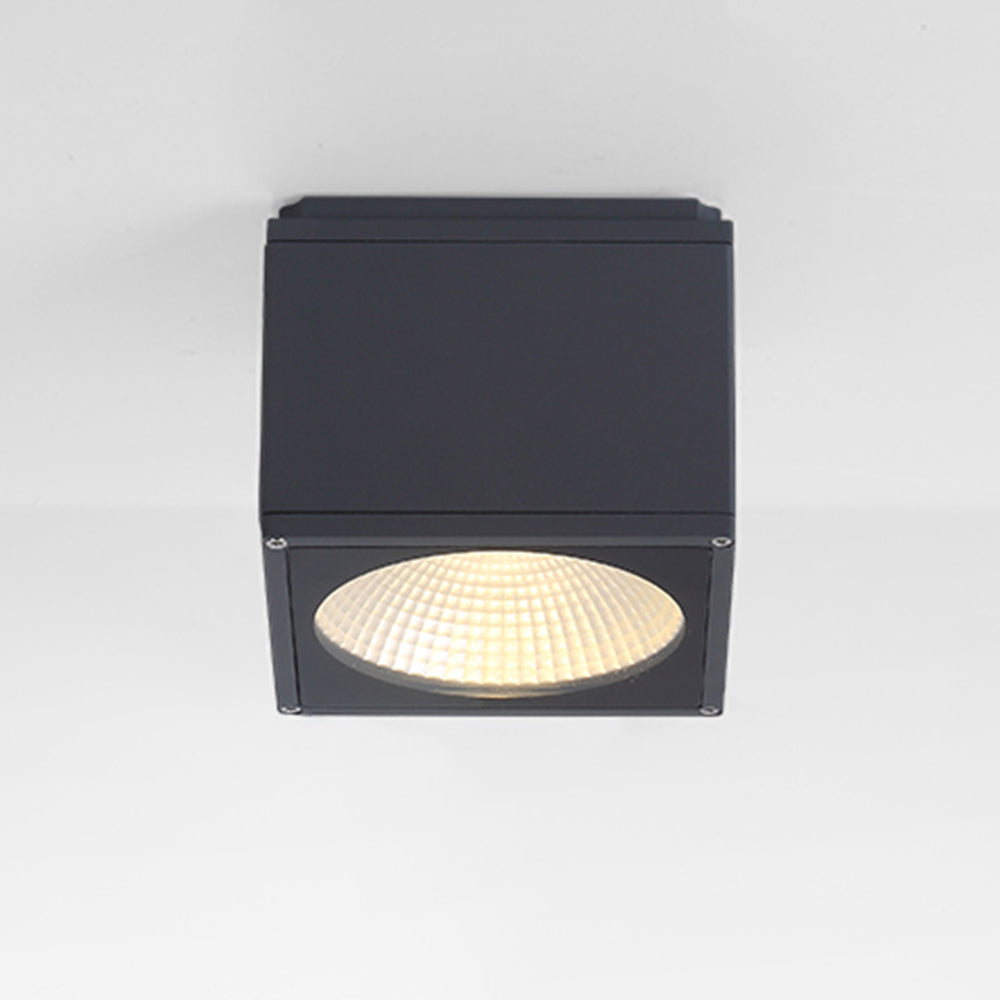 Black Orr close-up of the square face frame, four corner screws, upper seam and glowing circular faceted reflector.