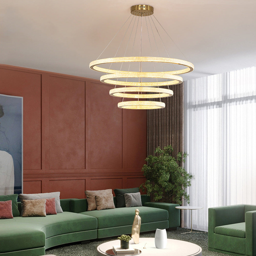 Four level Kirsten rings above green living-room seating and round white table, rust-red paneled wall and window at right