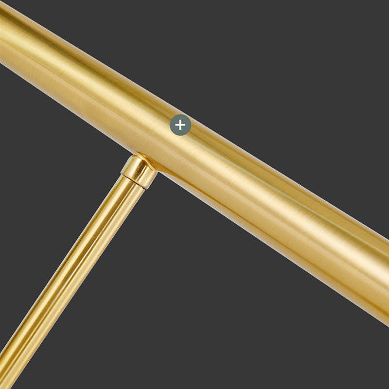 Louise close-up of the gold-tone bar and perpendicular support connection, showing grooves along the metal surface.