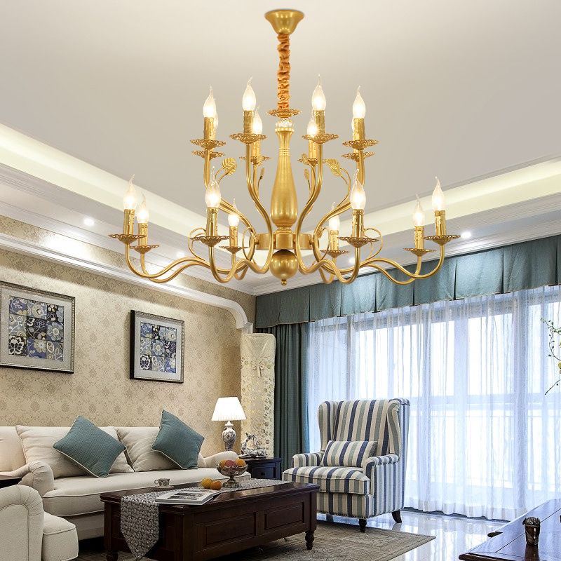 Gold 16-Light Marilyn above a pale sofa and wood coffee table beside a blue-striped chair and sheer-covered windows.