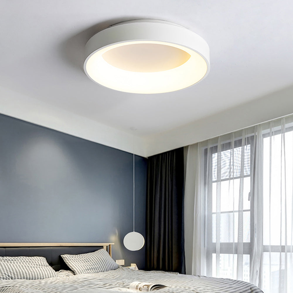 White Quinn ceiling light over striped bedding and dark headboard, with blue-grey wall, sheers and separate bedside pendant.