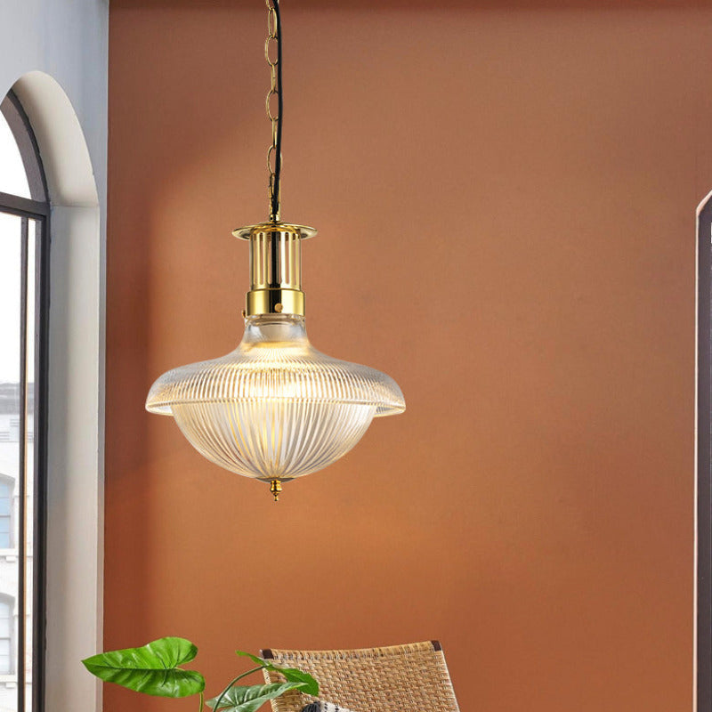 Alessio fluted glass pendant beside an arched window and woven chair.