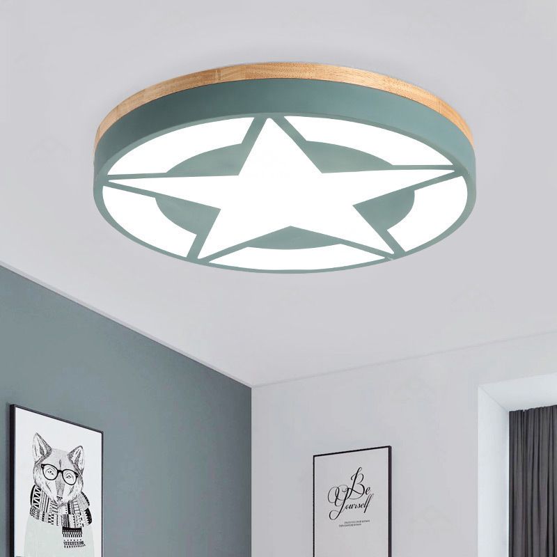 Green round star-pattern ceiling light beside framed fox art and a blue-green wall
