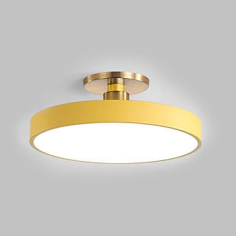 Close yellow round ceiling fixture with white diffuser, short stem and gold-tone ceiling fittings