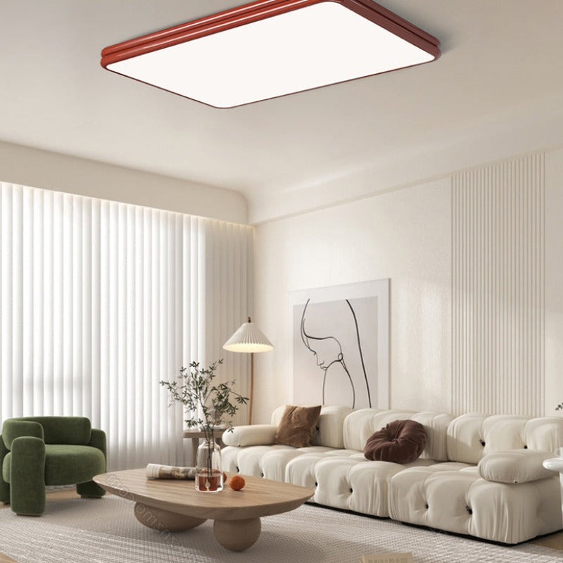 Red rectangular Valentina ceiling panel above a living-room sofa