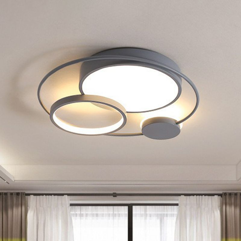 Gray Lacey circular ceiling light illuminated above a room with curtains.