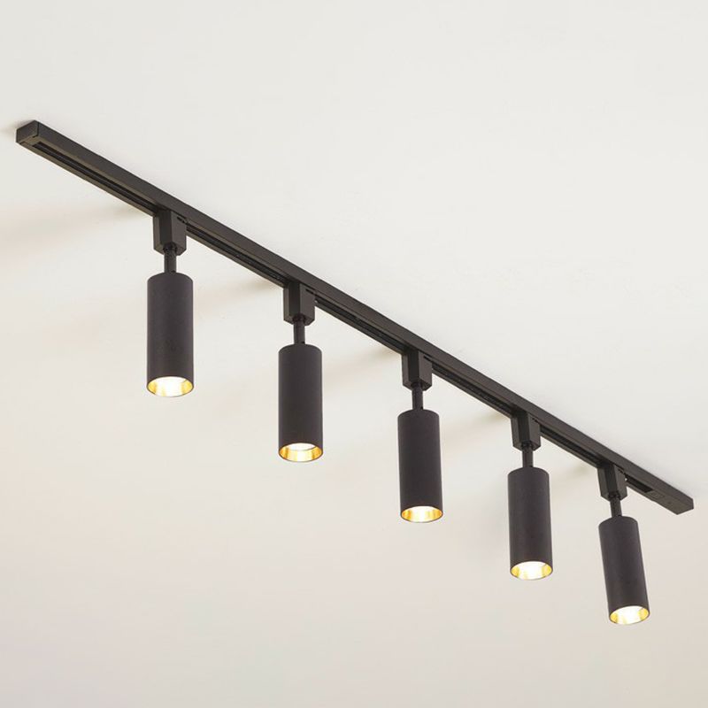 Large black five-head ceiling spotlight with longer cylinders and lit gold-tone interiors