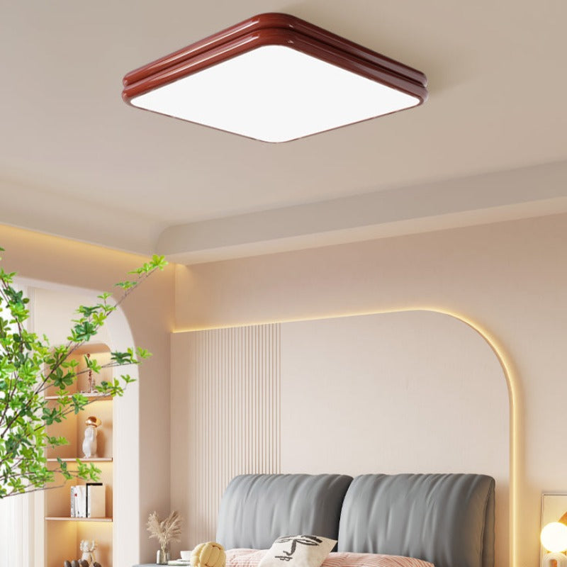 Red square Valentina ceiling light in a bedroom with a green plant