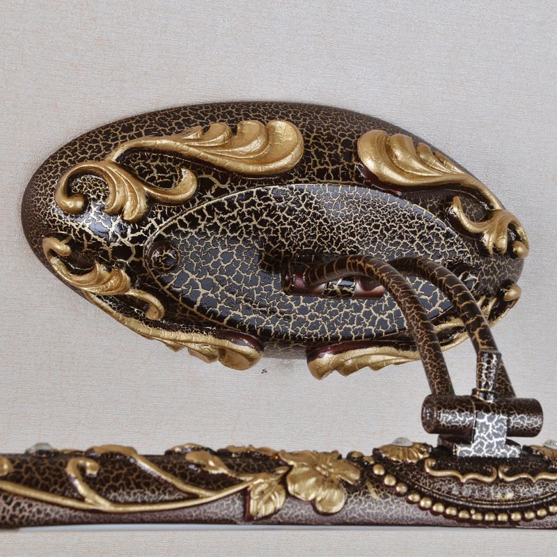Close-up of Félicie oval crackle-look backplate and raised scroll details