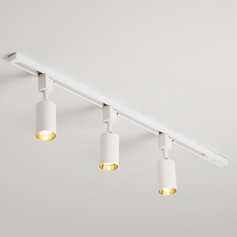 Small white three-head ceiling spotlight with short cylinders on a white rail