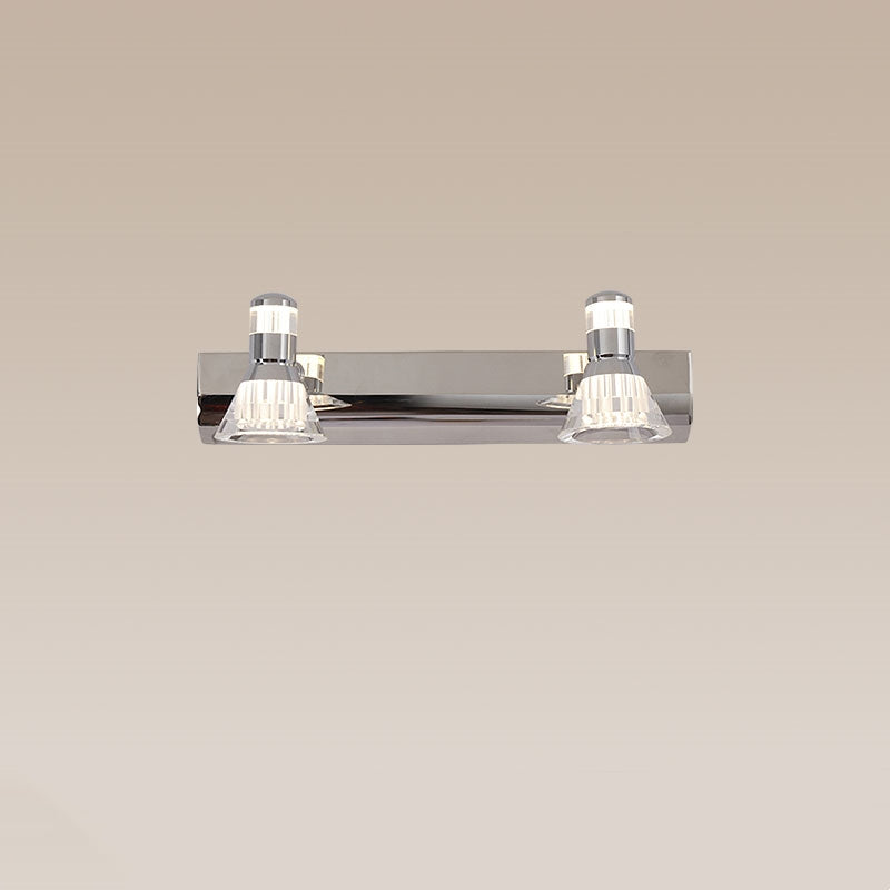 Kristy two-head silver wall light with clear cone heads on a beige background