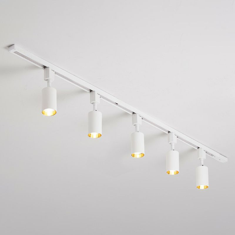 Small white five-head ceiling spotlight with short cylinders on a white rail