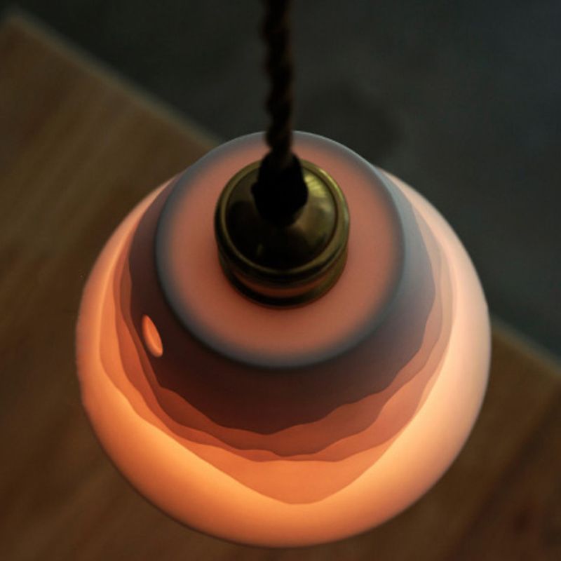 Overhead view of glowing Lottie cone, wavy relief bands, metal holder and twisted cord