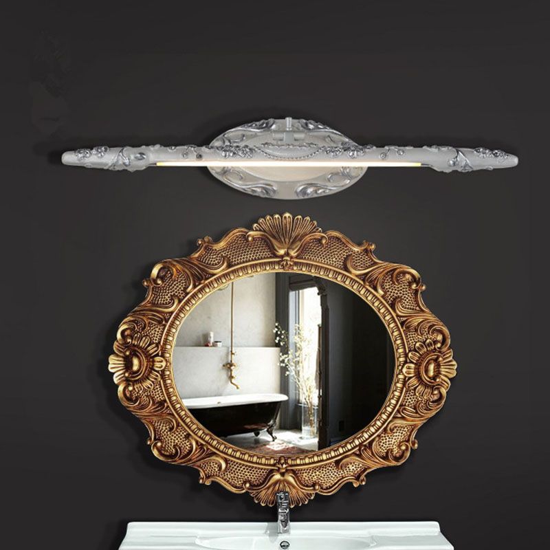 Félicie white-silver wall light above an ornate round mirror