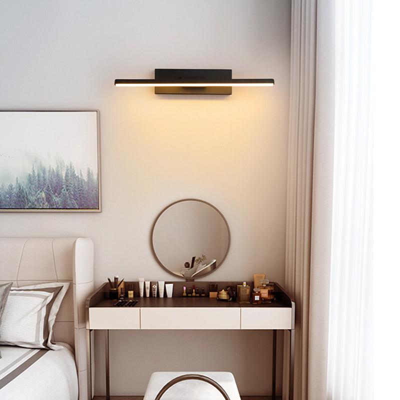 Horizontal black LED wall light above a bedroom vanity mirror