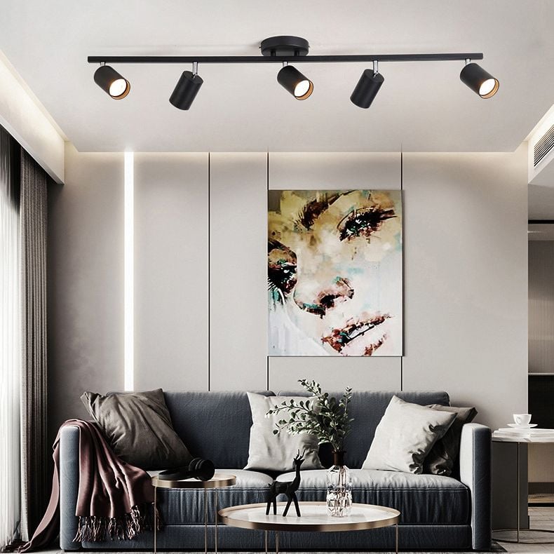 Black Freja five-head spotlight above a dark sofa