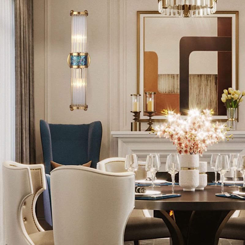 Clear-rod wall light with blue-green center in a dining interior with chairs, mirror and table