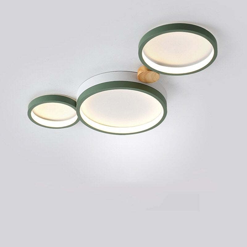 Green three-head ceiling light with white acrylic faces and a wood connector