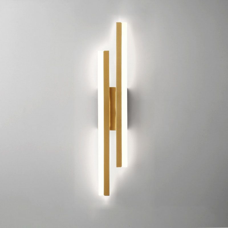 Gold-tone wall light with the right bar starting higher and the left bar extending lower