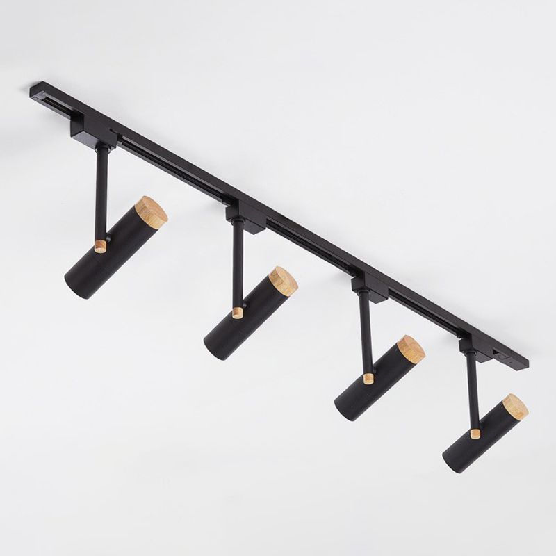 Black four-head ceiling spotlight rail with wood caps and angled cylinders