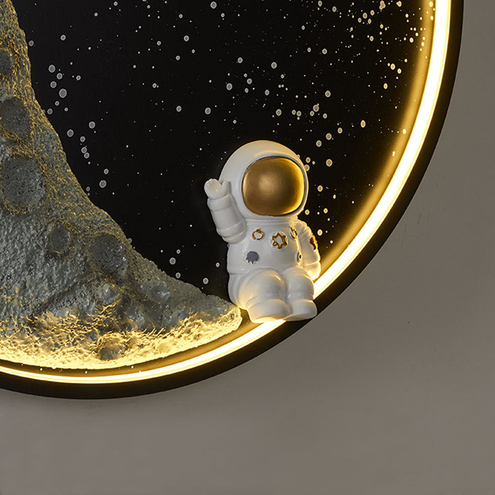 Close-up of Elif white astronaut with gold-tone visor and raised arm beside the crescent and glowing rim