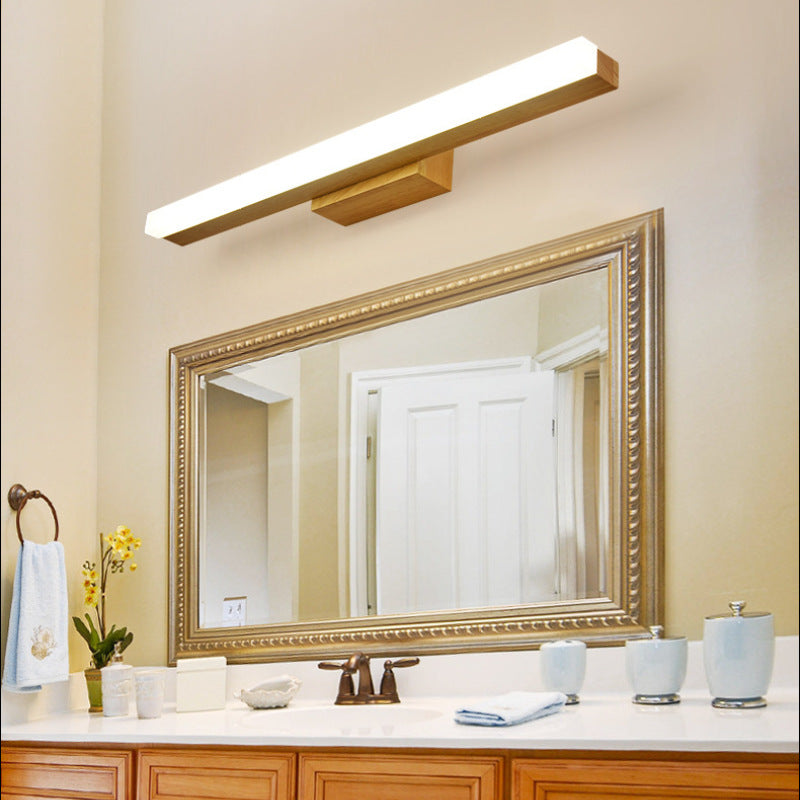 Wooden Leigh light above an ornate framed mirror
