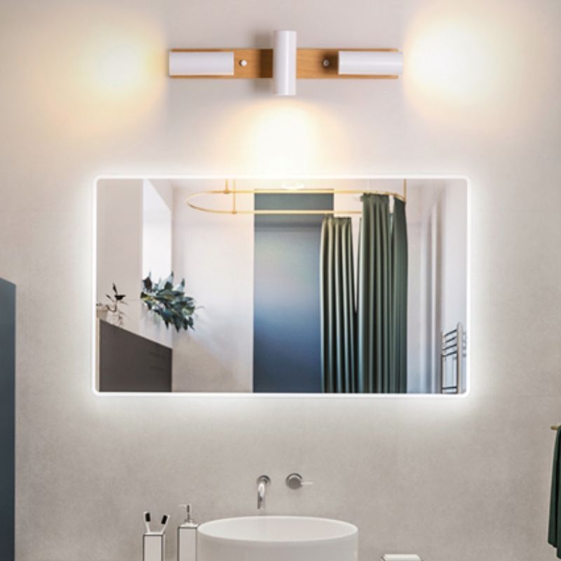 Three white Ozawa spots above a separate bathroom mirror, outer heads horizontal and center head down