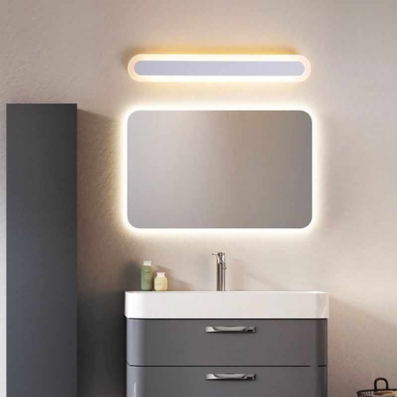 Edge White capsule fixture above a rounded rectangular mirror