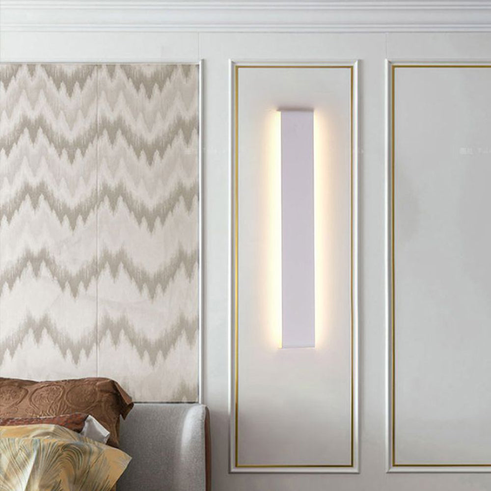 White Edge light mounted vertically on a decorative wall panel.