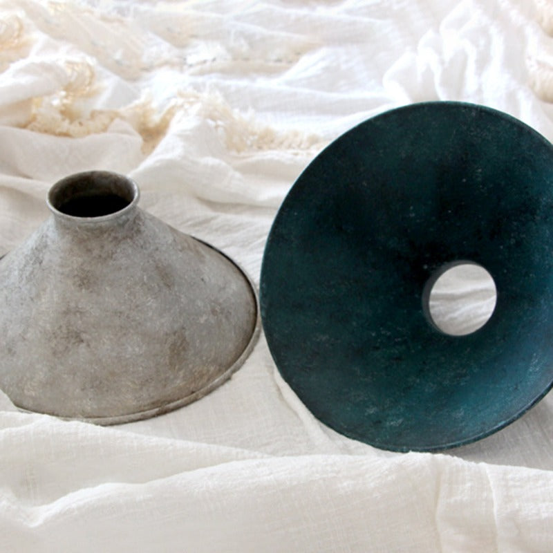 Loose silver and blue cone shades on white fabric, showing the blue shade underside and center opening