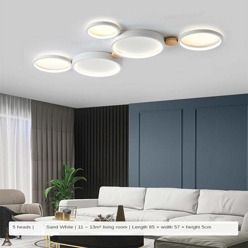 White five-head ceiling light above a sofa, with a caption showing 85 by 57 by 5 cm