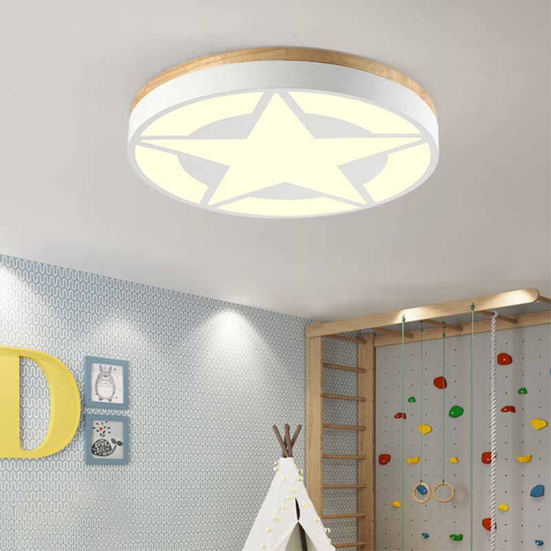 White star-pattern ceiling light above a playroom climbing wall and tent, with a warm-looking glow