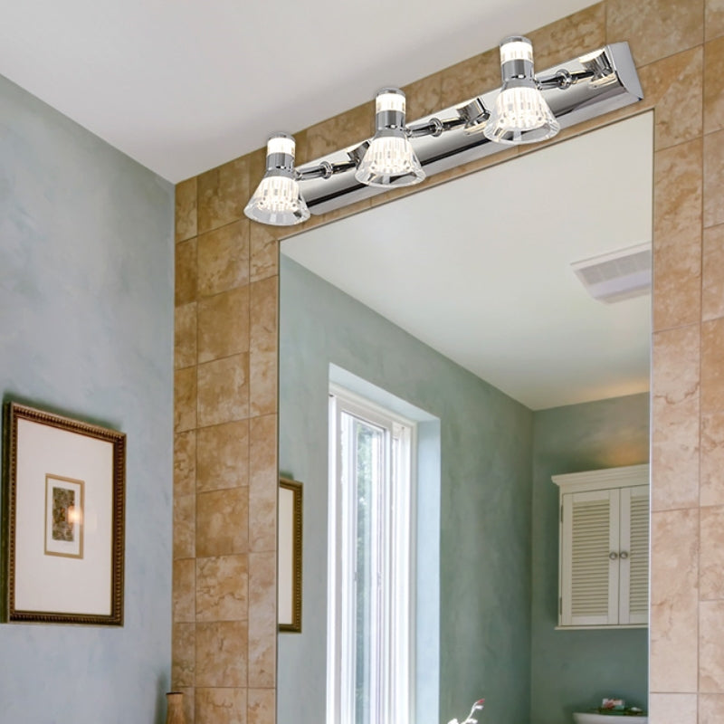Kristy three-head silver vanity wall light above a rectangular bathroom mirror with a tiled frame