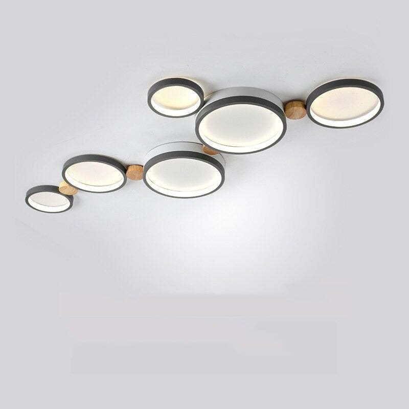 Gray six-head ceiling light with linked round acrylic faces and contrasting wood connectors